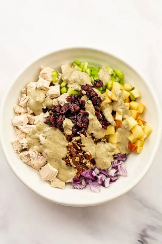 Tahini dressing added on top of the pecan cranberry chicken mixture.