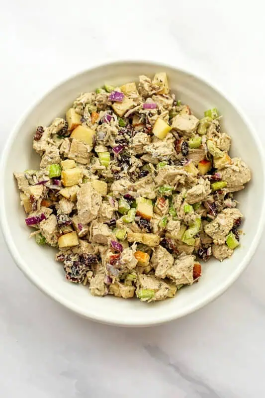 Cranberry pecan chicken salad in a white bowl after mixing well.