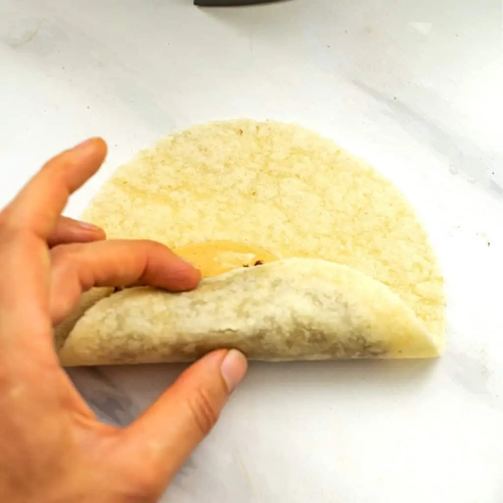 Hand rolling a vegan taquito.