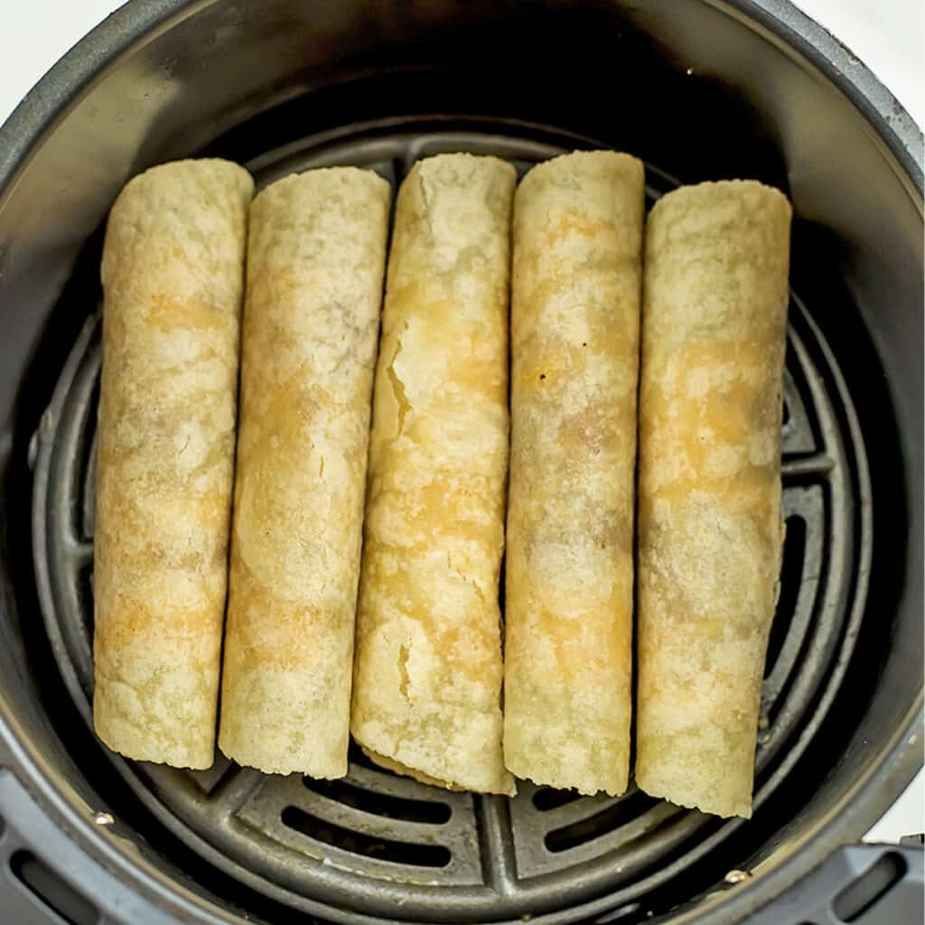 Vegan taquitos in air fryer before cooking.
