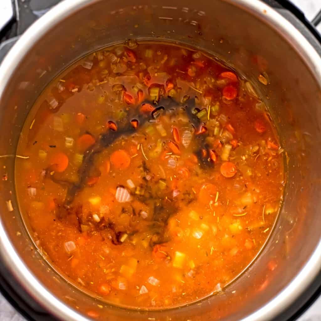 Balsamic vinegar and broth added to veggies in instant pot.
