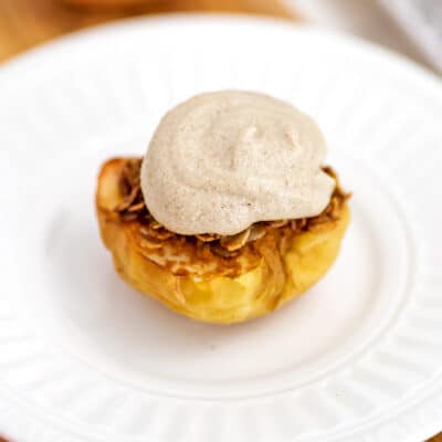 Air fried apple topped iwth frosting on a white plate.