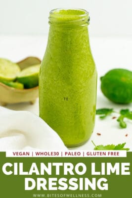 Bottle filled with cilantro lime dressing, lime in background.