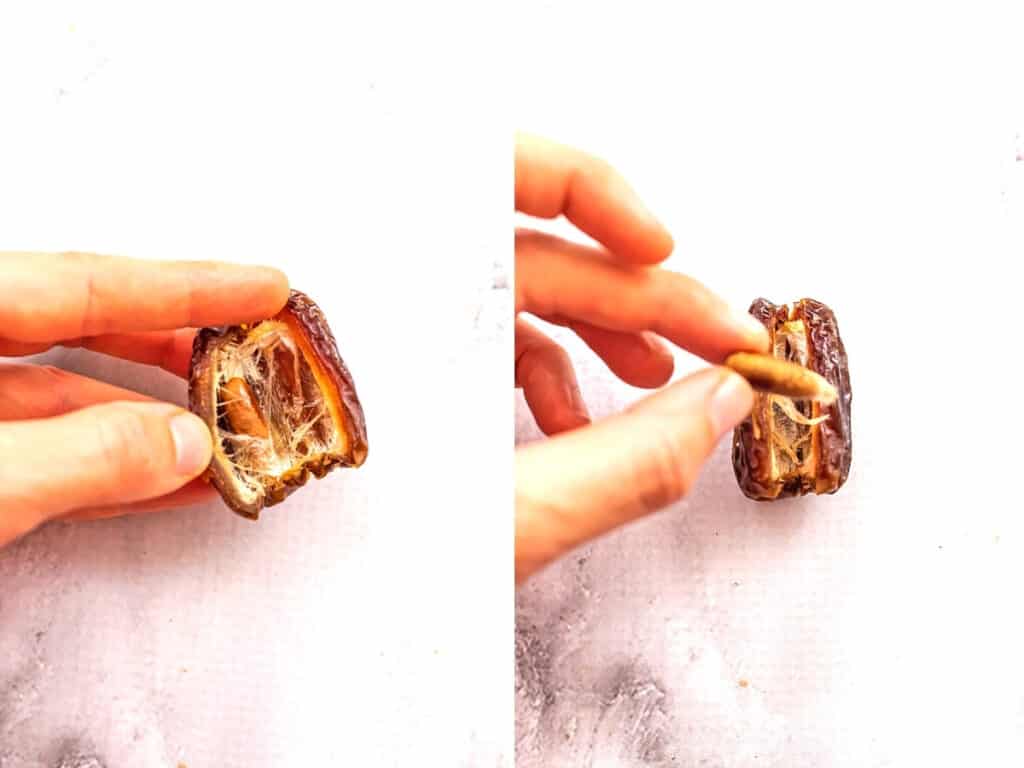 Medjool date cut in half with pit being removed.