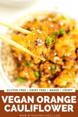Chopsticks holidng a piece of orange cauliflower.