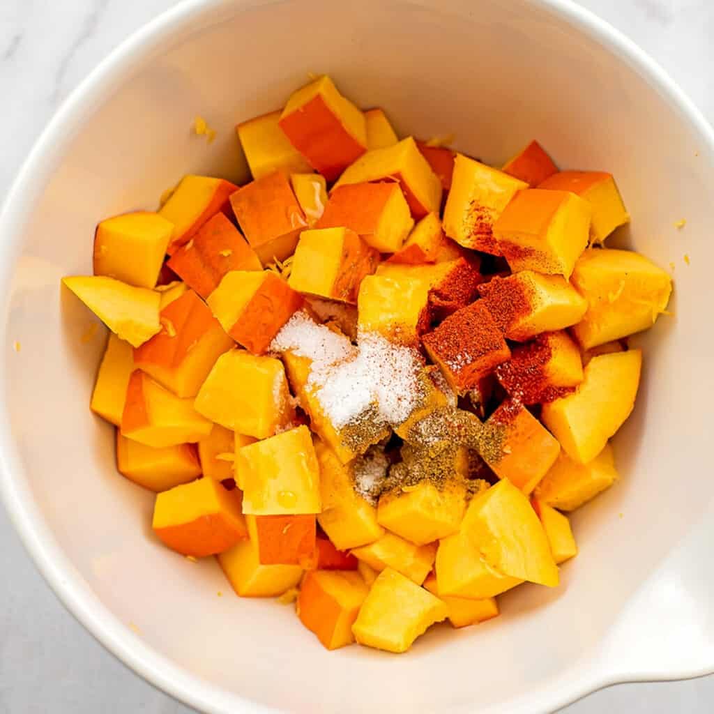 Pumpkin cubes with salt and seasoning on top.