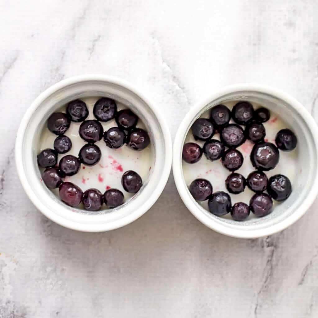 Frozen blueberries in 2 ramekins.