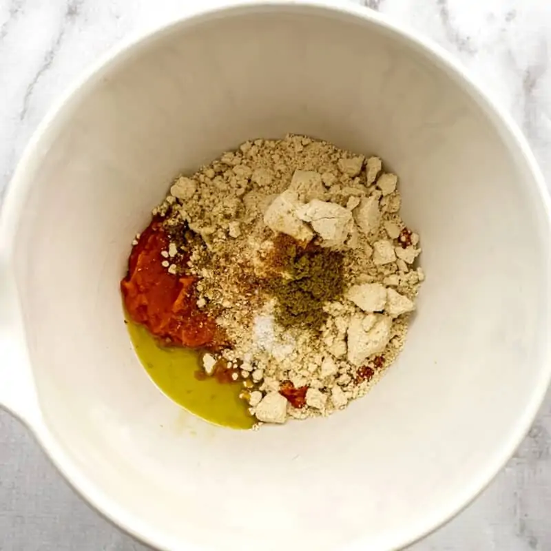 Pumpkin gnocchi ingredients in a bowl before mixing.