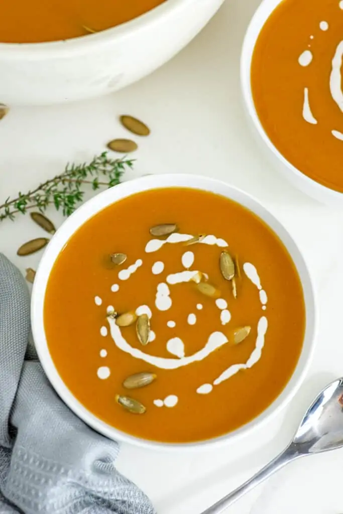 Bowl of whole30 butternut squash soup with pumpkin seeds on top.