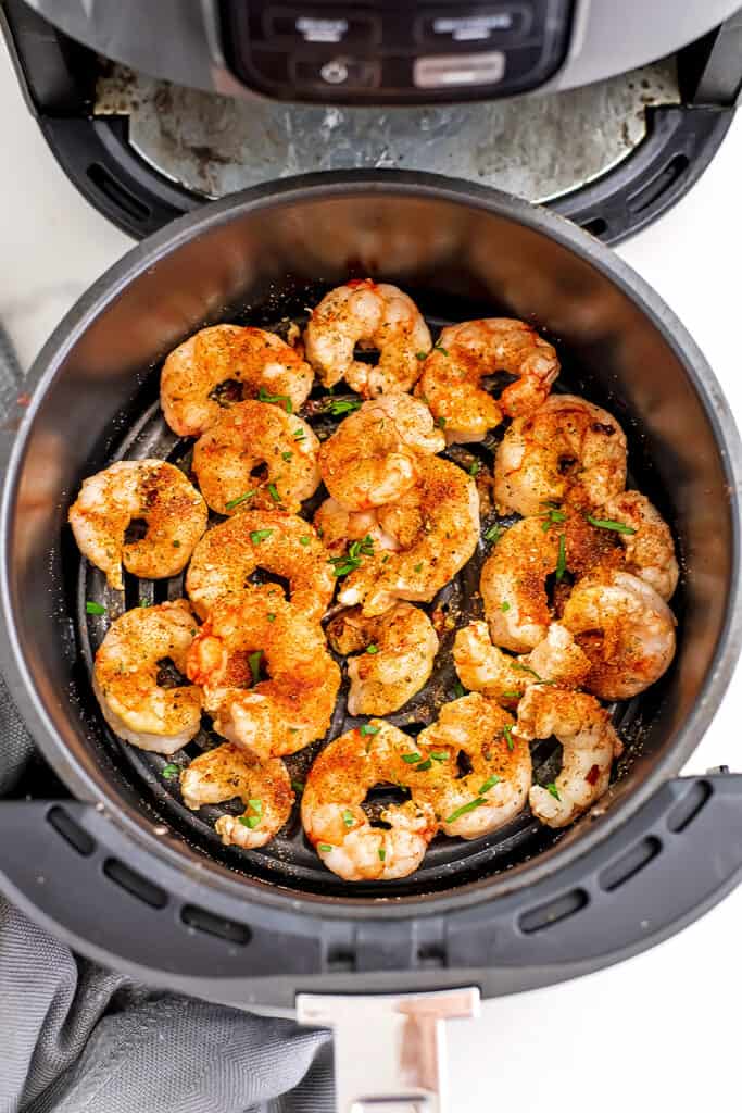 Shrimp in air fryer basket.