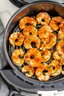 Frozen shrimp after cooking in air fryer basket.