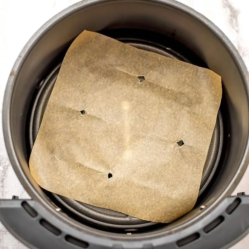 Parchment paper in air fryer basket.