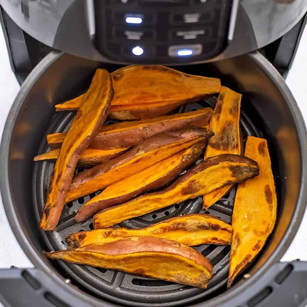 Sweet potato wedges in air fryer after cooking.