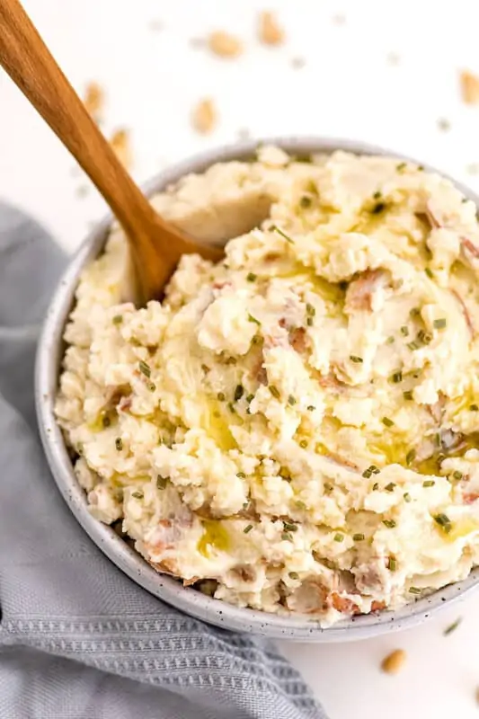 Wooden spoon in bowl of whole30 mashed potatoes.