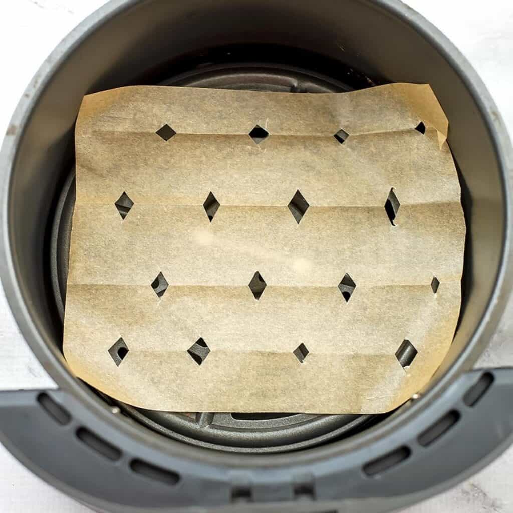 Parchment paper in air fryer basket.