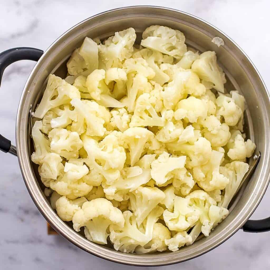 Cauliflower in steaming basket after steaming.