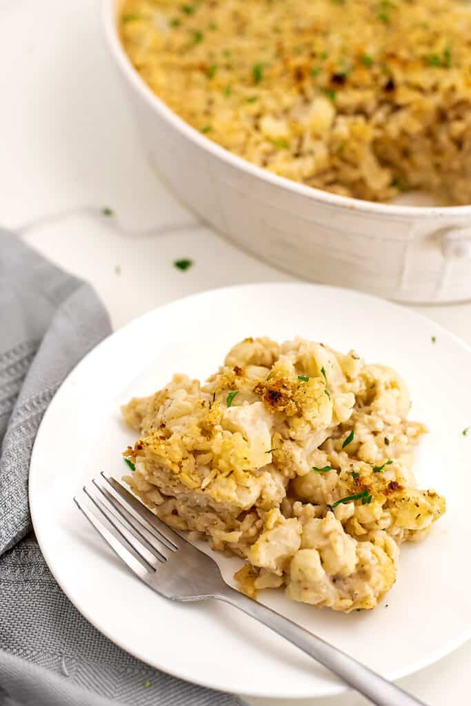 Cauliflower vegan casserole on a white plate with fork on plate.