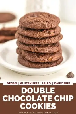 Large stack of double chocolate chip cookies on white plate.