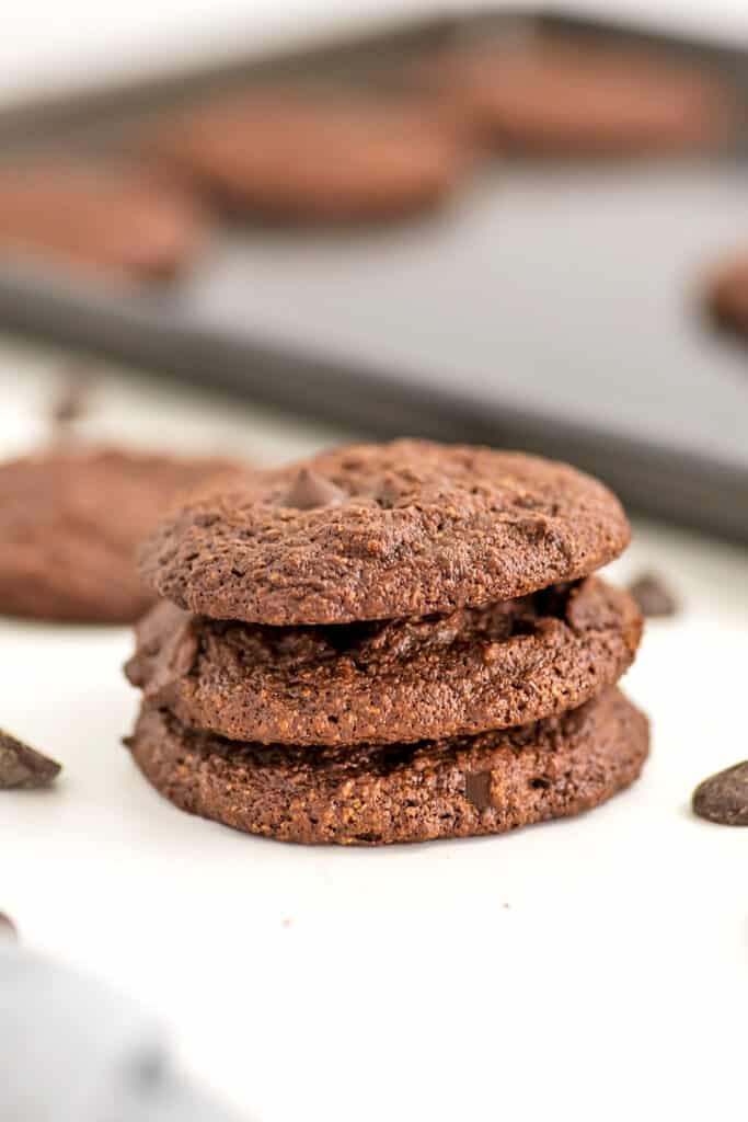 Vegan chocolate cookies stacked on top of each other.