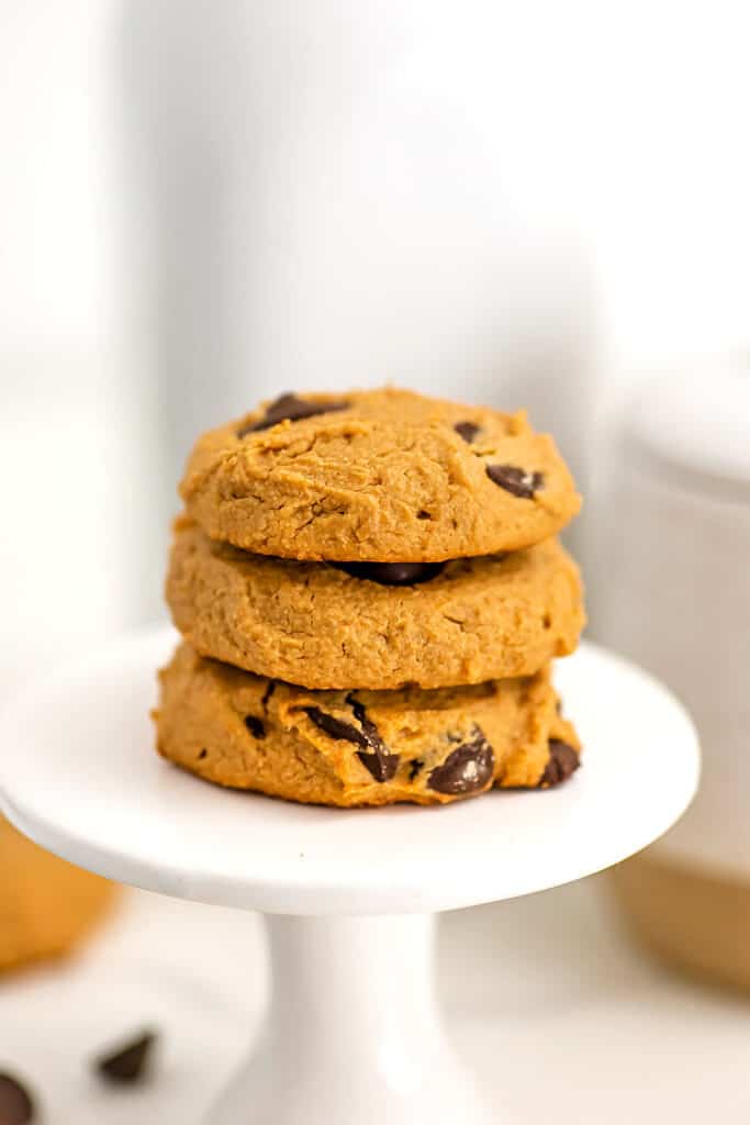 Three vegan chocolate chip peanut butter cookies on pedistal.