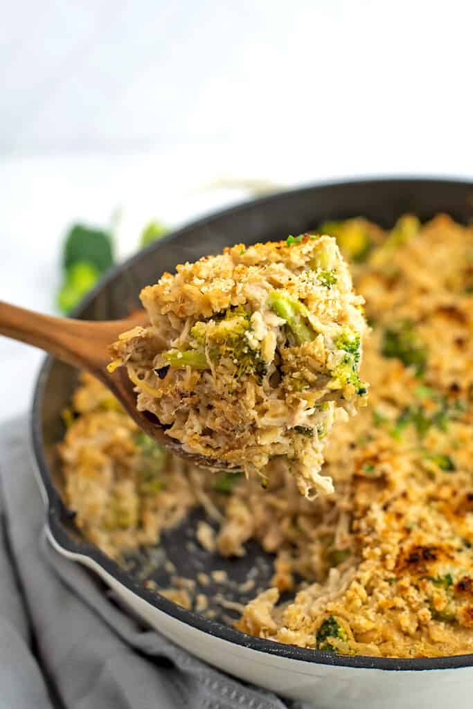 Spoonful of chicken and rice casserole over the skillet. 