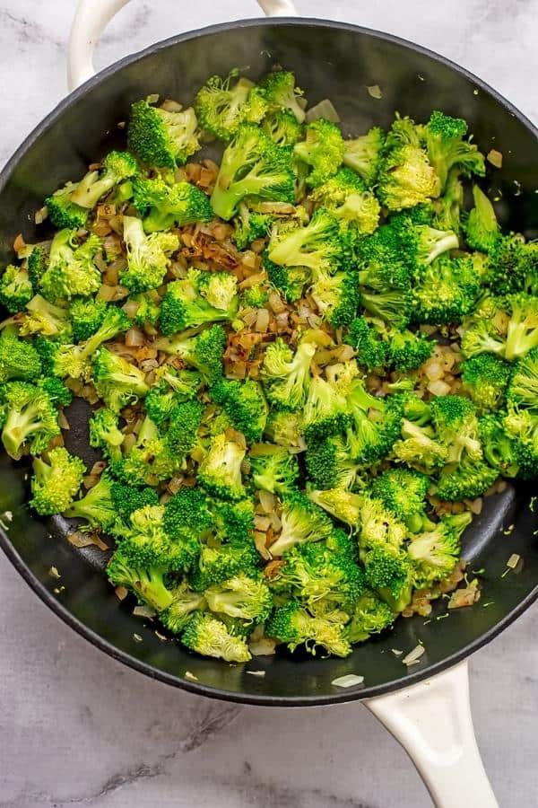 Broccoli and onions in a skillet.