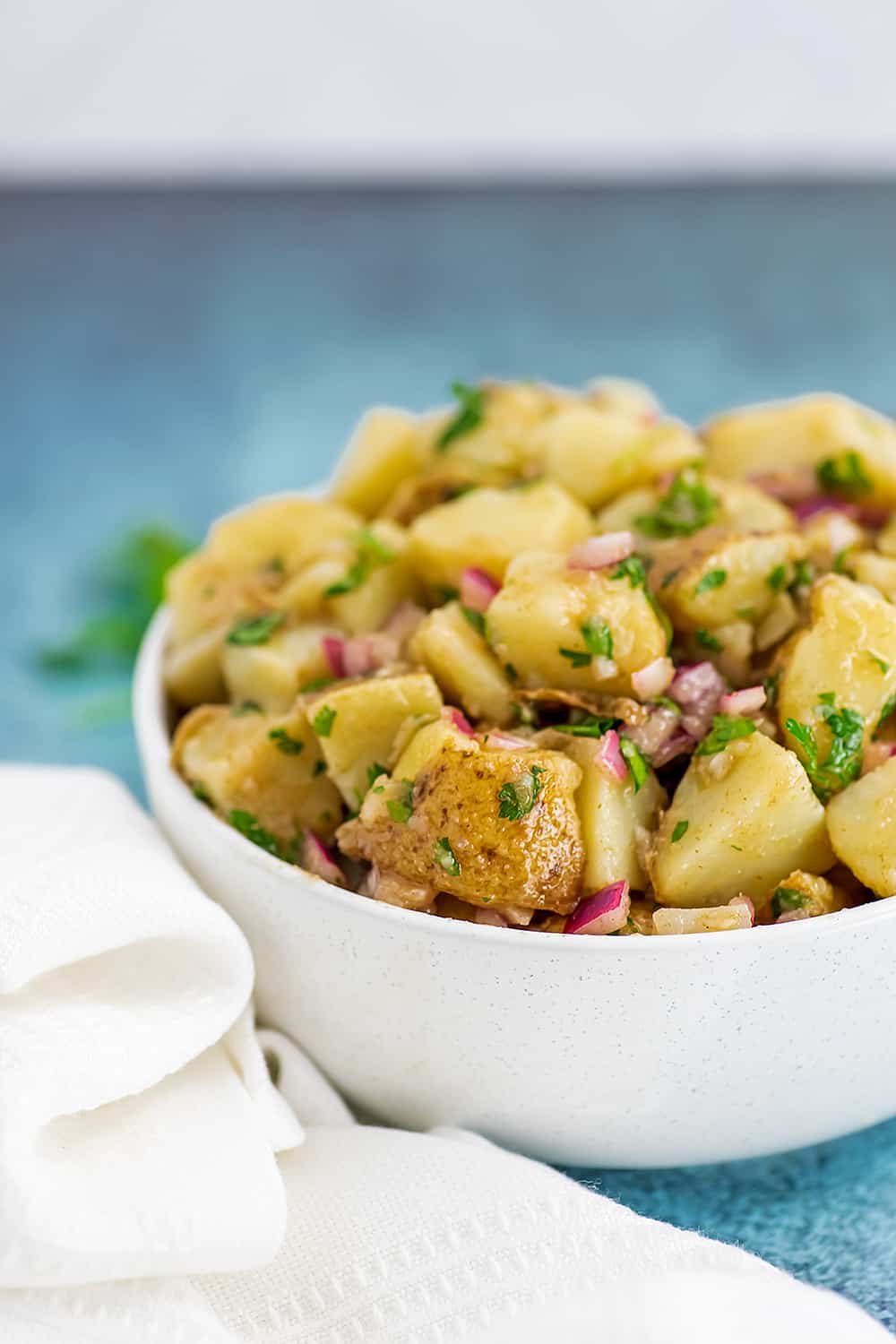 White bowl filled with Moroccan potatoes salad.