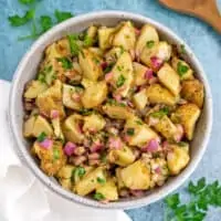 Moroccan potato salad in a bowl with white napkin on the side.