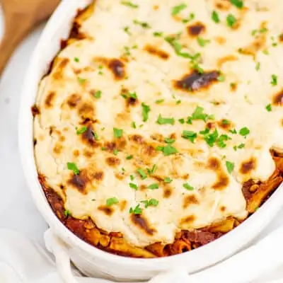 White casserole dish filled with vegan baked ziti.