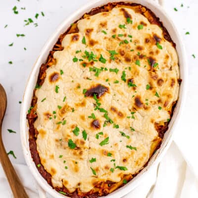 Dairy free baked ziti in oval white casserole dish.
