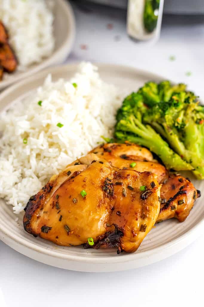 Plate filled with rice, steamed broccoli and teriyaki chicken cooked in air fryer.