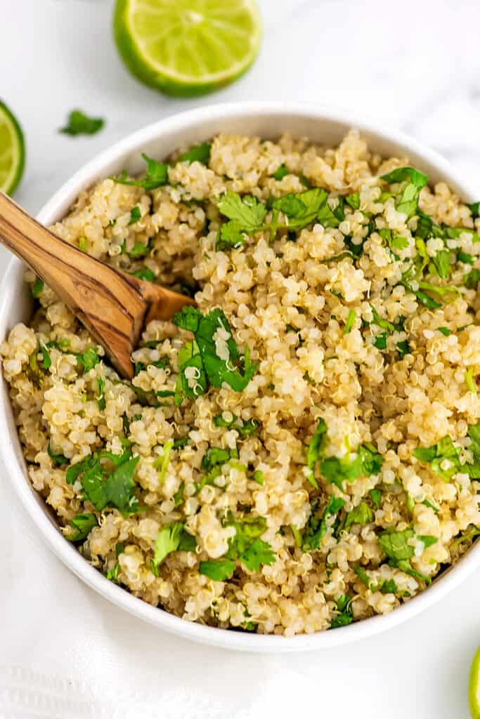 Wooden spoon in bowl filled with Mexican quinoa. 