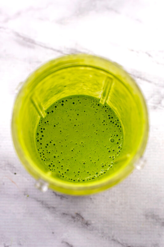 Cilantro lime vinaigrette in blender cup after blending.