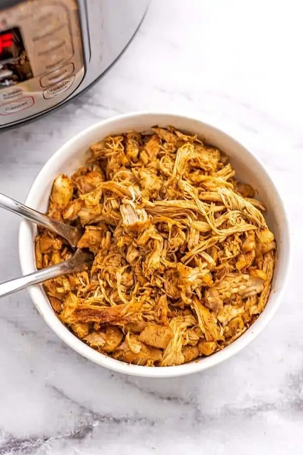 Bowl filled with instant pot shredded Mexican chicken.