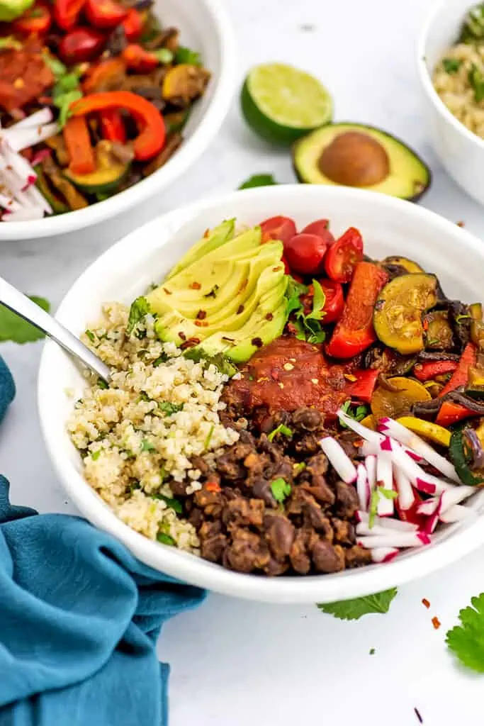 Lage white bowl packed with Mexican Buddha Bowl ingredients.