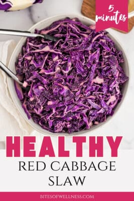 Tongs resting in a bowl of red cabbage slaw