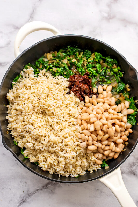 Brown rice, white beans, sundried tomatoes added to skillet with sauteed veggies.