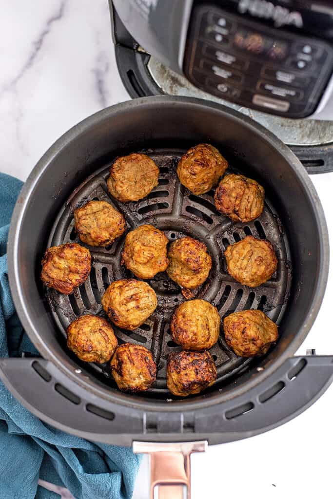 Chicken meatballs cooked in the air fryer basket.