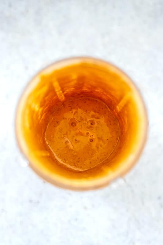 Carrot and Banana smoothie in blender cup after blending.