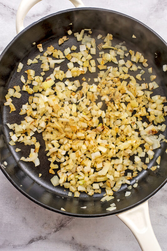 Chopped onions sauteed in a large cast iron skillet.