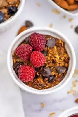Chocolate chips and raspberries on top of air fryer baked oatmeal.