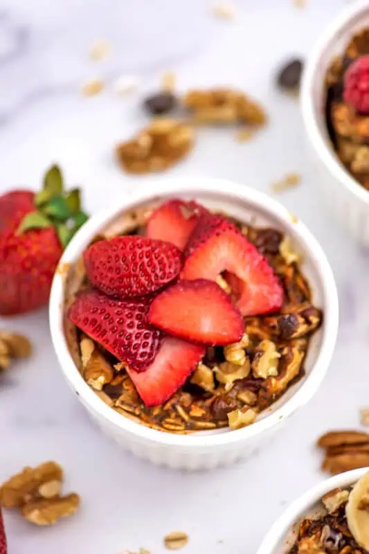 Sliced strawberries and walnuts over air fryer baked oats.