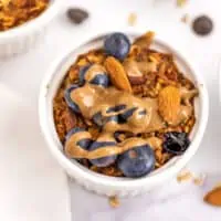 Air fryer baked oatmeal with blueberries, almonds and almond butter on top.