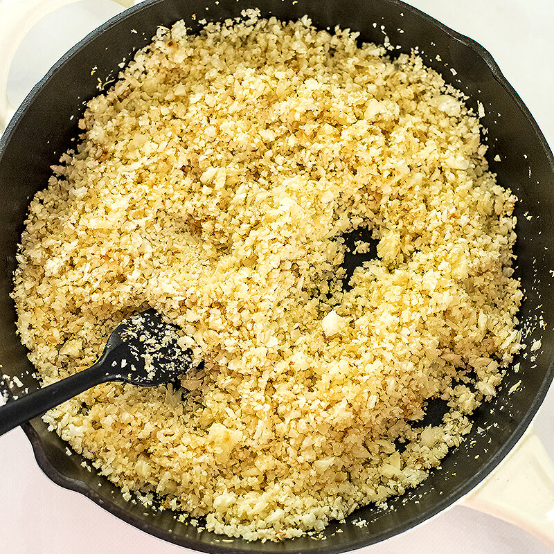 cooked cauliflower rice in a large cast iron skillet.
