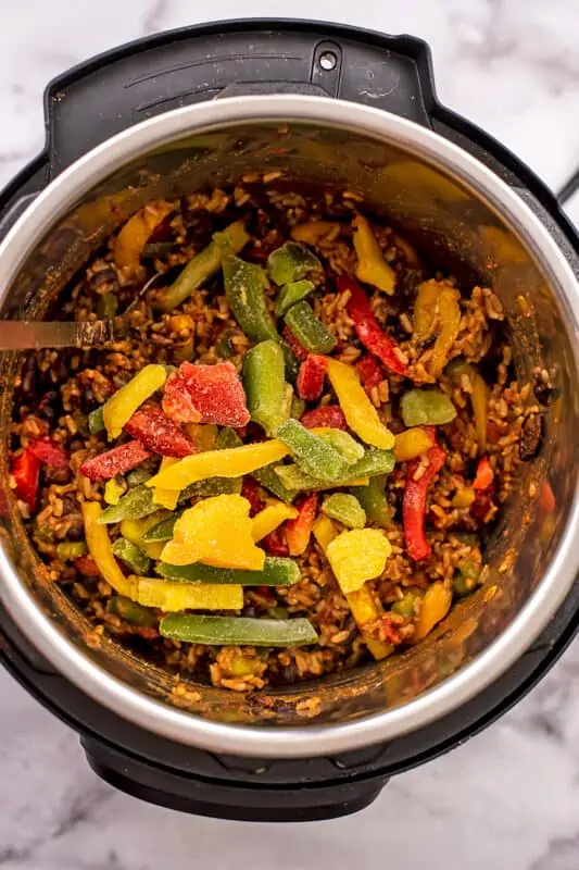Frozen bell peppers added to the instant pot with rice and beans.
