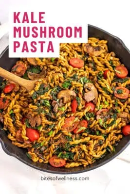 Large skillet filled with kale mushroom pasta.