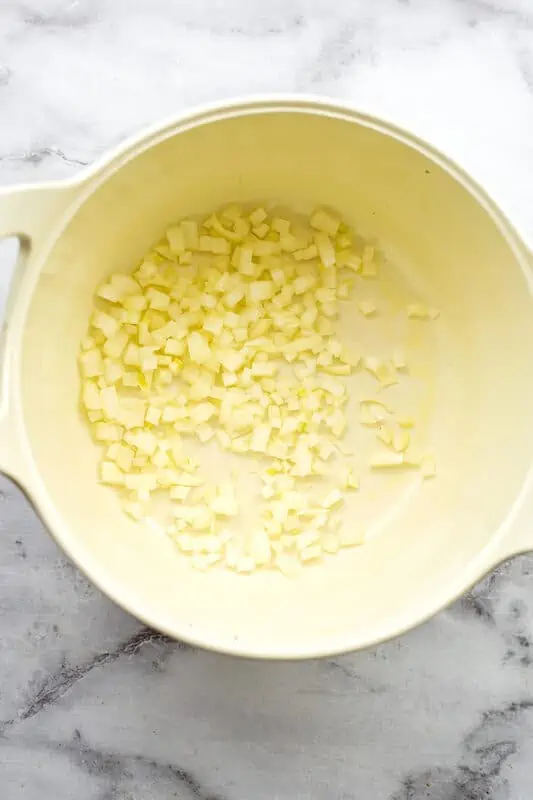 Chopped white onions in a white pot.