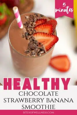 Large glass filled with chocolate strawberry banana smoothie with a few strawberries on top.