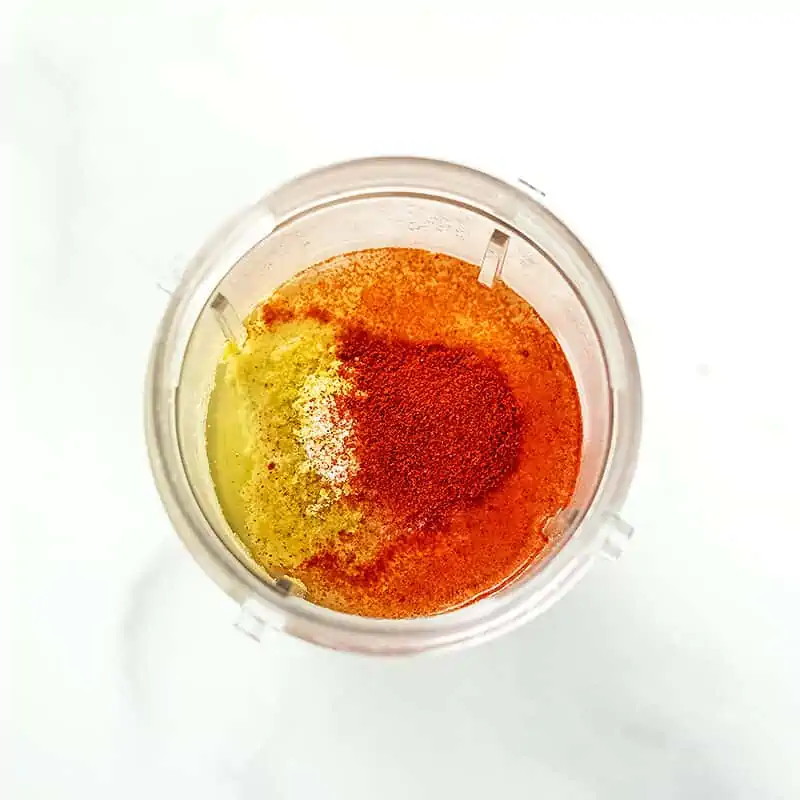 Bullet blender filled with ingredients to make dairy free queso.