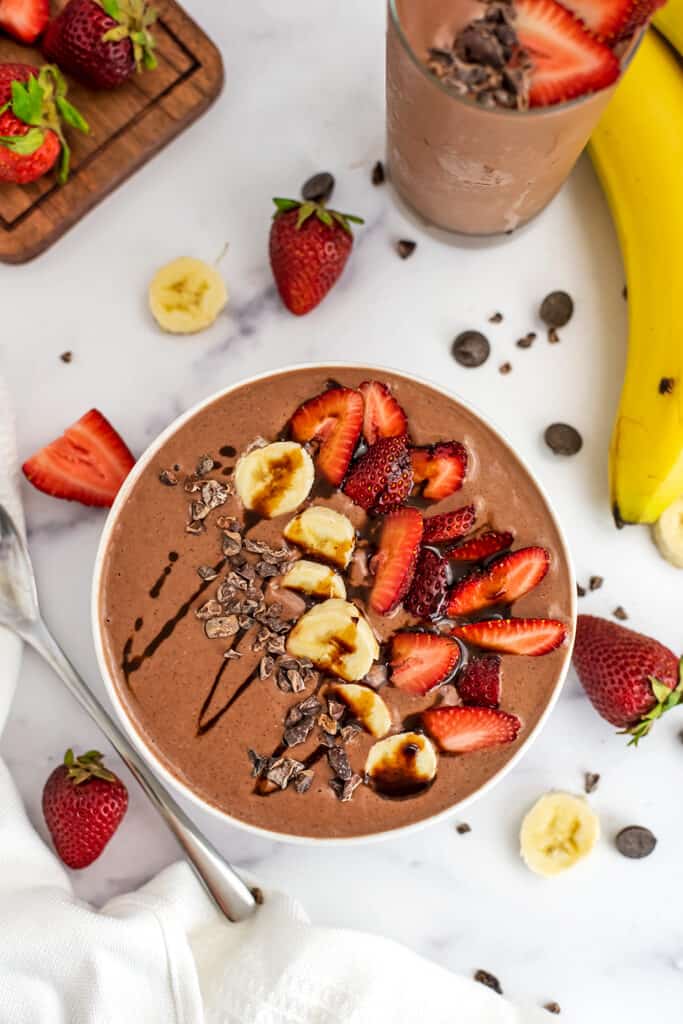 Chocolate banana strawberry smoothie bowl with sliced strawberries and bananas on top.